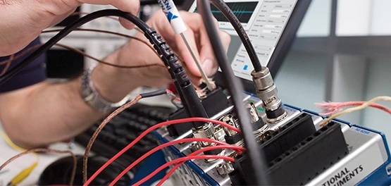 Engineer in the lab using DAQ equipment.