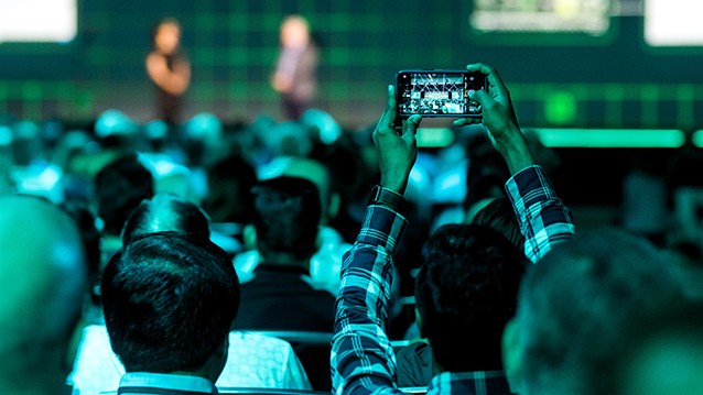 NI Connect attendee taking a picture during a Keynote presentation.