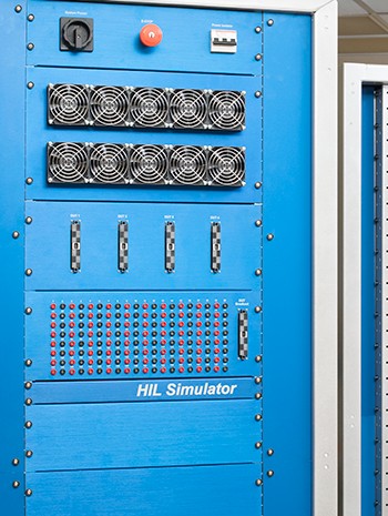 Three hardware in the loop test rack standing next to each other.  