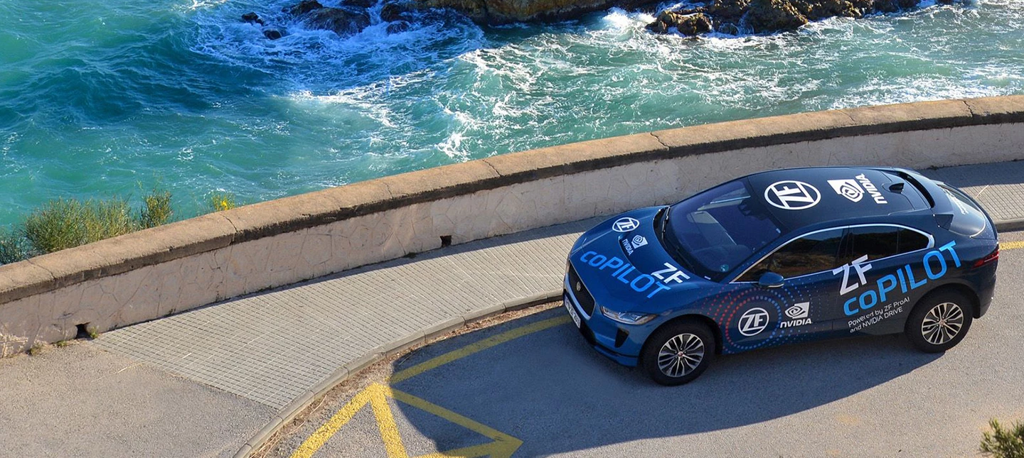 Autonomous vehicle powered by ProAI is parked next to seawall