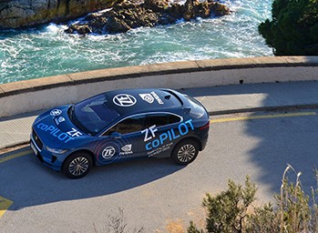 Autonomous vehicle powered by ProAI is parked next to seawall