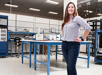 A systems engineer at NI poses in her research and development lab.