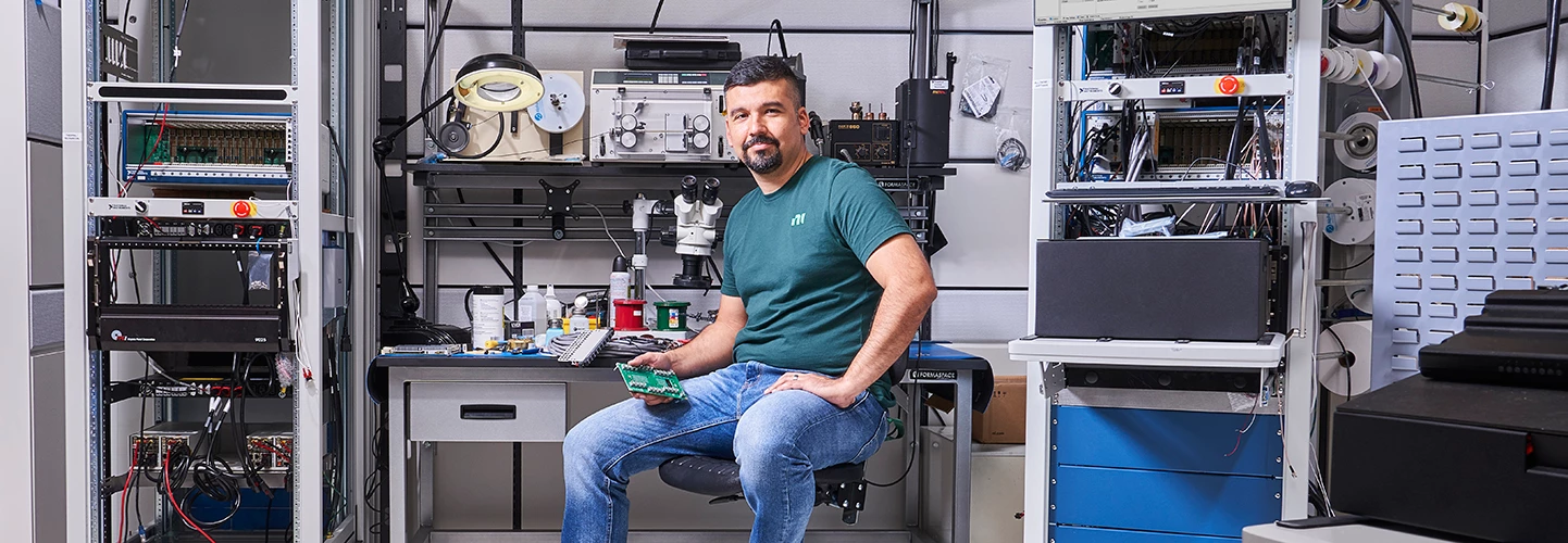 An NI engineer works on the ECU Test System