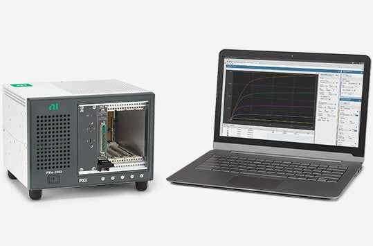 PXI LCR Meter bundle next to a monitor displaying a signal measured on InstrumentStudio software.