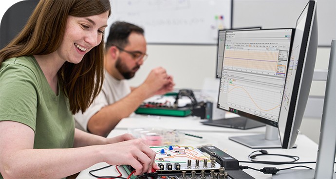 Two engineering students using Digilent Analog Discovery Max (ADS Max) in a classroom setting
