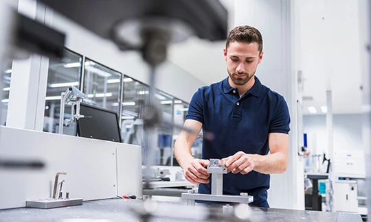 A test engineer in a laboratory evaluates the conditions under which a device will fail.