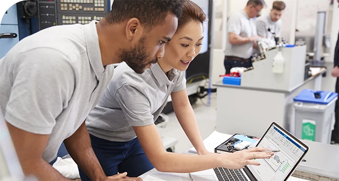 two engineers looking at test results on a laptop