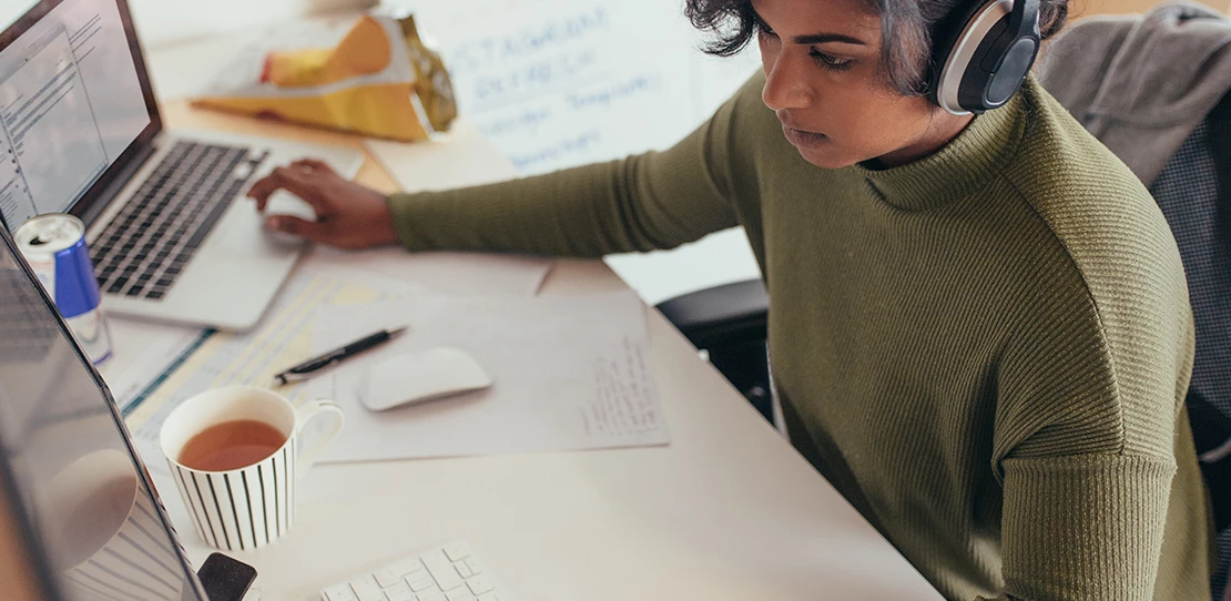 An engineer attends virtual meetings with her team from her home office.