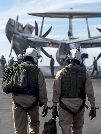 Flugbesatzung geht auf Militärflugzeug zu