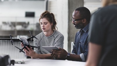 Two professionals work on classroom training exercises.