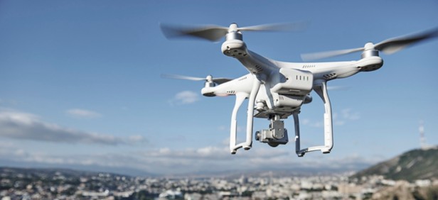 drone with digital camera hovering over city