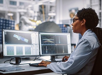 Engineers integrating and testing a satellite bus.