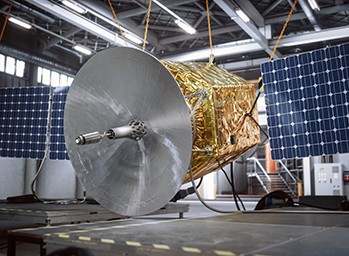 Engineers integrating and testing a satellite bus