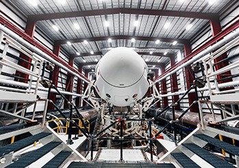 an engineering working on satellite test data on her computer in a lab