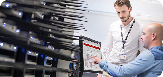 Two engineers at a wireless test workstation 