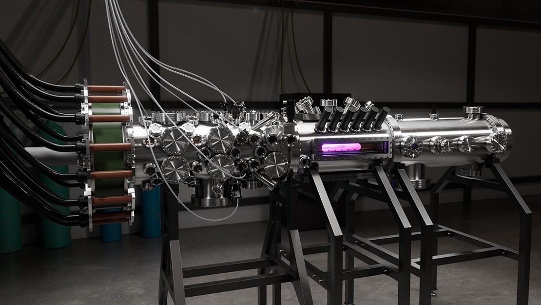 Close view of a compact fusion energy device, featuring a long cylindrical vacuum chamber with numerous valves, cables, and sensors, mounted on a frame with a purple plasma glow visible inside.