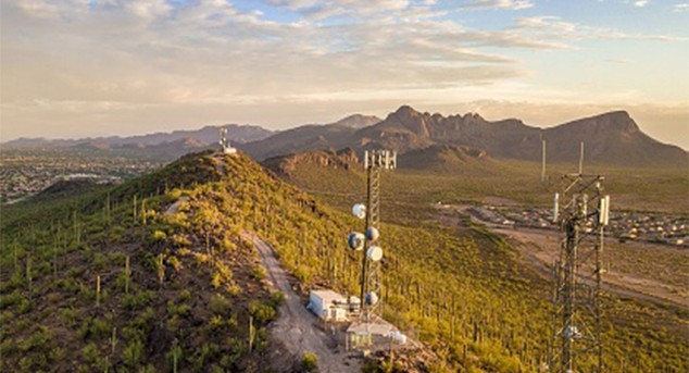 Antenna towers on a hillside at dusk