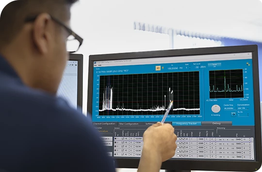 An operator points at captured signals on a signals intelligence user interface.