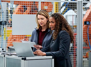 two technicians working at their laptops