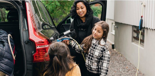 Family charging their SUV before a trip