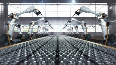 Robotic arms operating alongside a conveyor belt, illustrating real-time automated control and precision monitoring enabled by LabVIEW Real-Time.