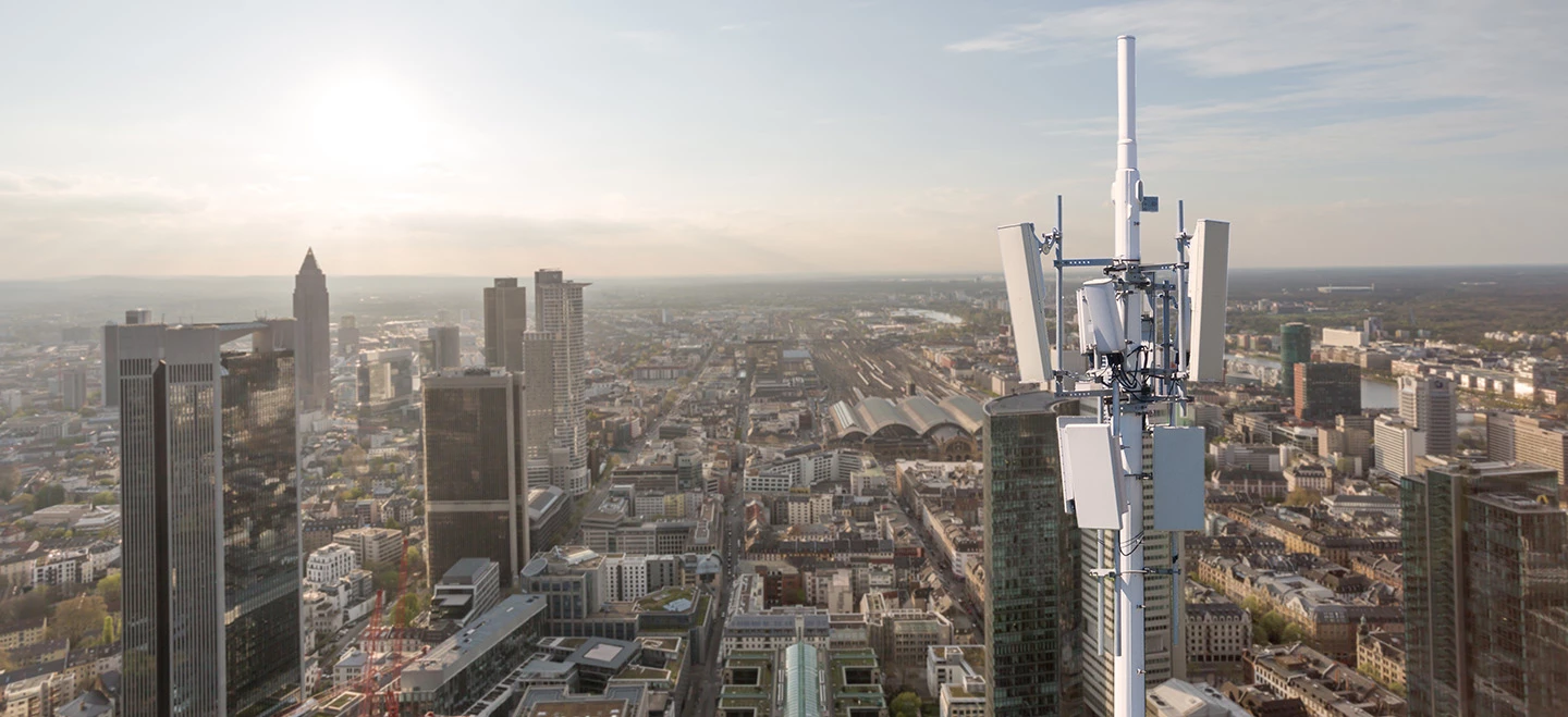 close up of a cell phone tower with a city background