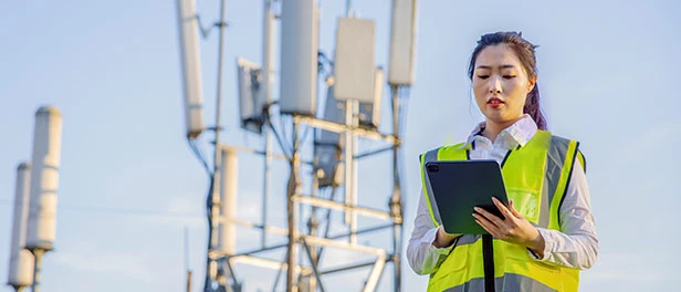 Test engineer standing in front of a radio unit