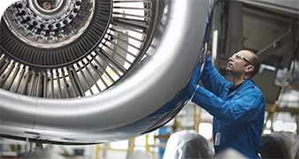 Mechanic testing a jet turbine engine