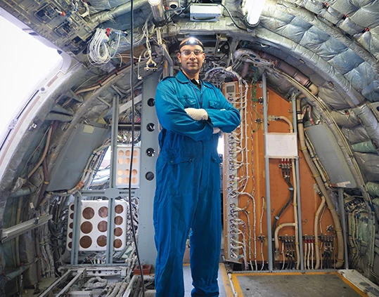 Aircraft engineer working on interior of 737 jet airplane