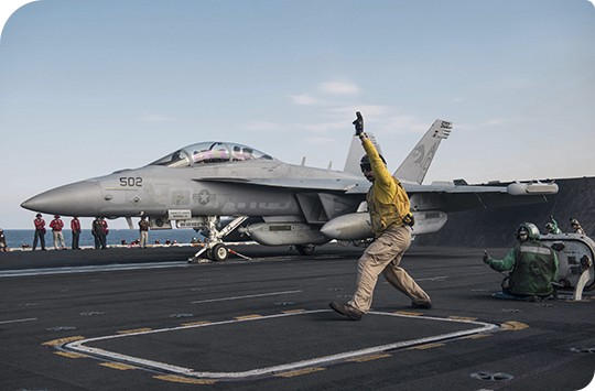 US Navy fighter jet launching from aircraft carrier