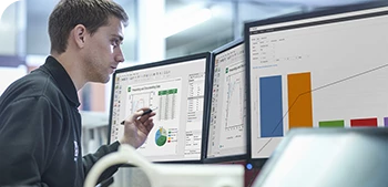 man reviewing data on computer monitor