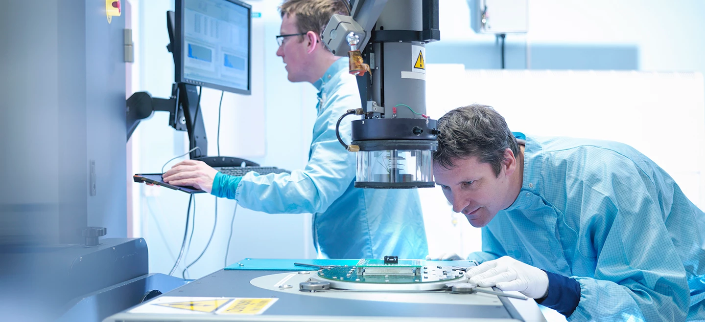 A pair of semiconductor engineers validate mixed signal ICs in a modern lab