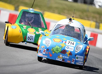 Drivers race energy efficient vehicles around the track during the Shell Eco-marathon.