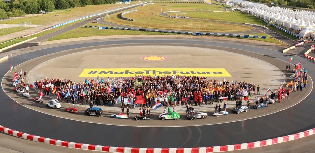 Teams of engineers and drivers from around the world pose with their cars and flags around the Shell Eco-Marathon racetrack featuring the hashtag Make The Future