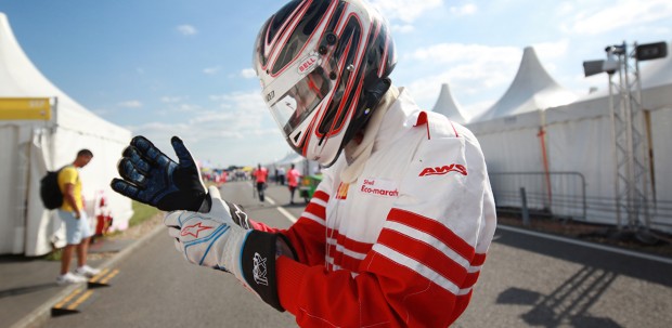 A driver dons protective gloves in preparation for the Shell Eco-marathon