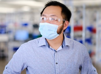 David Weng, lead developer at Velentium, stands on the production floor wearing a mask.
