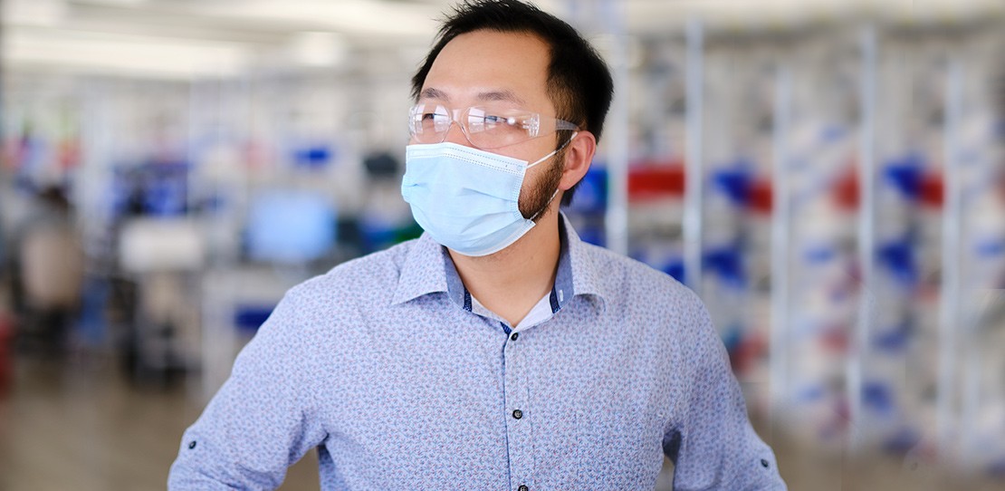 David Weng, lead developer at Velentium, stands on the production floor wearing a mask.