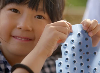 Close up of smiling girl learning the basics of engineering.