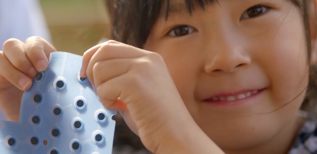 Close up of smiling girl learning the basics of engineering.