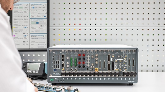 PXI Chassis with multiple PXI modules installed in a lab setting and used with NI Software.