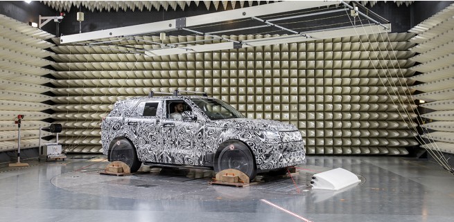 Jaguar vehicle in a testing facility with an array of sensors and signals making measurements.