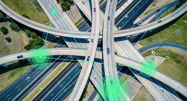 Aerial view of highway with illustration showing cars communicating over 5G signals