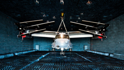 Aircraft positioned in an anechoic test chamber for system-level RF validation using integrated measurement instrumentation.
