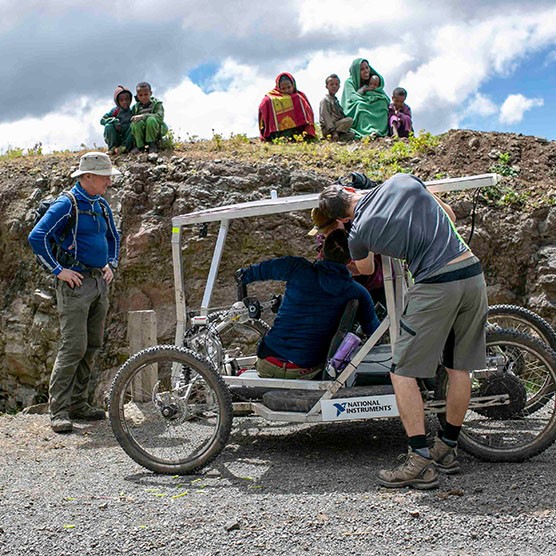 A team of engineers tests an electrically-assisted handcycle for safety with its driver