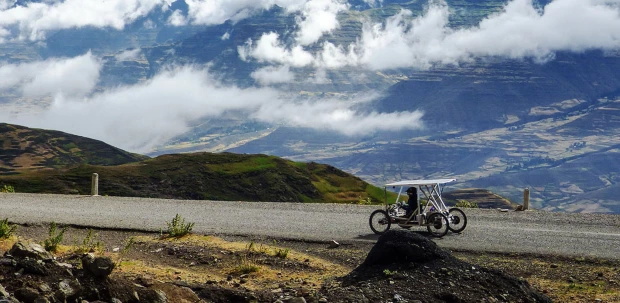 Electrically-assisted handcycle being driven along mountain road