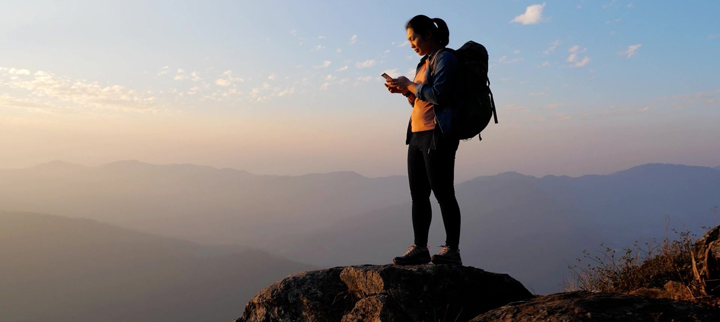 A hiker uses GPS in her phone to find her way.