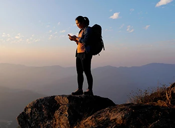 A hiker uses GPS in her phone to find her way.