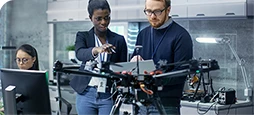 two engineers configuring a drone