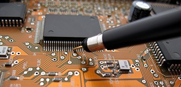 Close-up of a circuit-board with a probe.